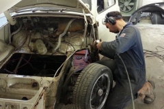 New front quarter being fitted to this '66 Beetle, many other repairs followed.